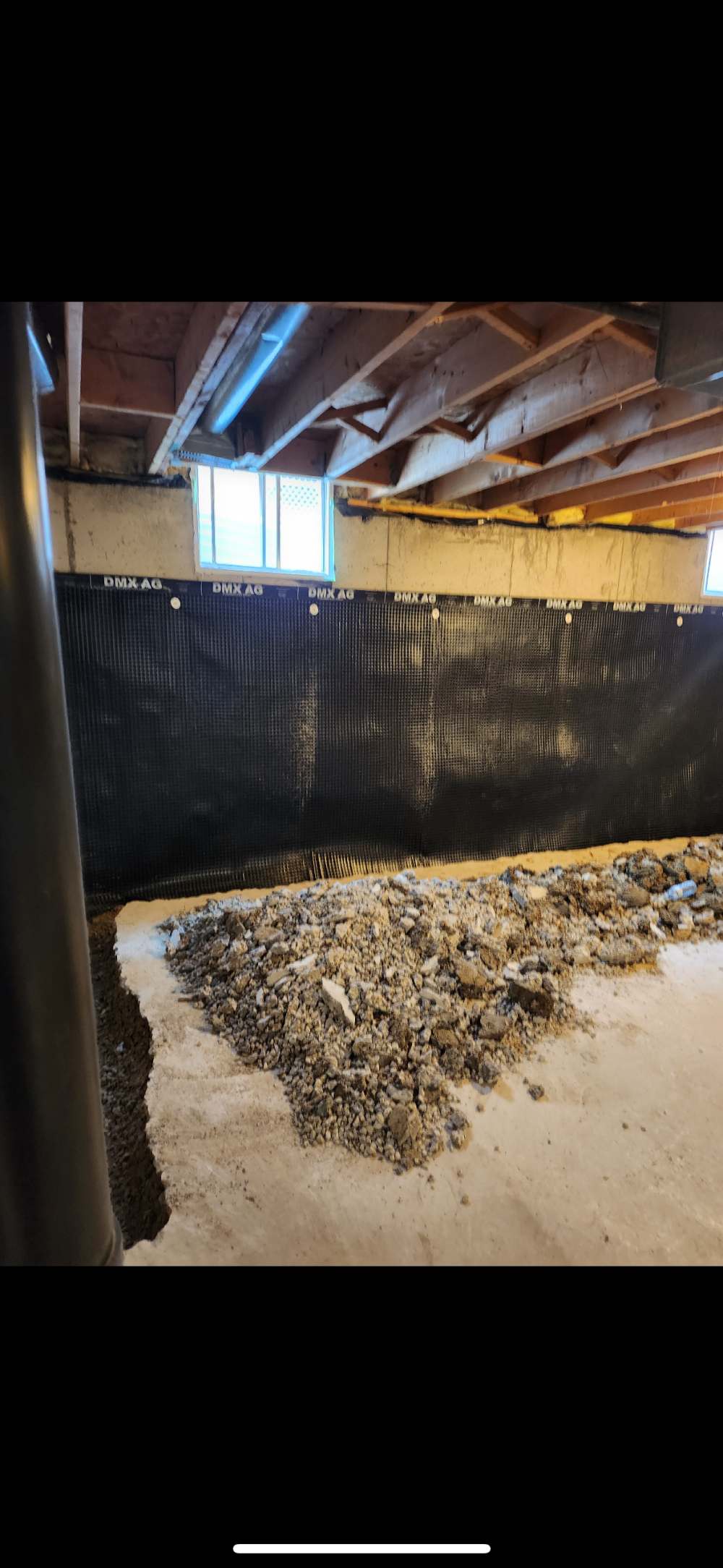 Interior basement wall with drainage membrane installed